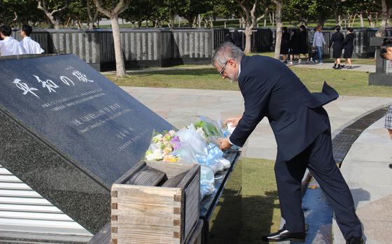 Pedro Oiarzabal, principal researcher for Sancho de Beurko’s Fighting Basques project, places flowers to honor U.S. service members of Basque descent that perished during the Battle of Okinawa during a Dec. 5, 2023 ceremony at the Cornerstone of Peace memorial in Itoman, Okinawa, Japan.