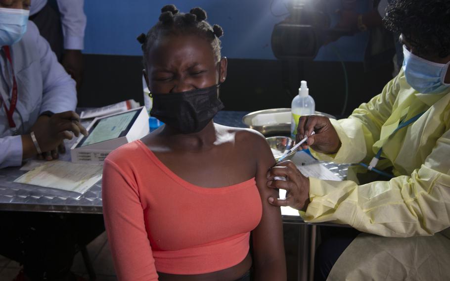 A young woman reacts as she receives a Pfizer jab against COVID-19, in Diepsloot Township near Johannesburg Thursday, Oct. 21, 2021. A new COVID-19 variant has been detected in South Africa that scientists say is a concern because of its high number of mutations and rapid spread among young people in Gauteng, the country’s most populous province, Minister of Health Joe Phaahla announced Thursday, Nov. 25, 2021.