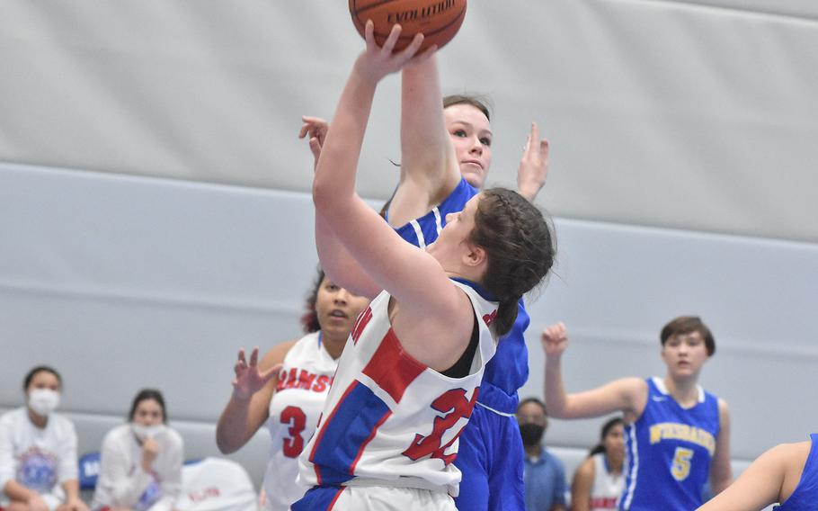 Ramstein’s Katya von Eicken gets a shot off despite the efforts of Wiesbaden’s Ella Kirk in the Royals’ win over the Warriors on Friday, Feb. 25, 2022, at the DODEA-Europe Division I basketball championships.