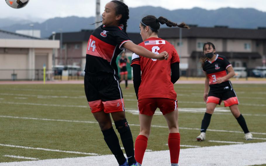 E.J. King's Miu Best gets set to play the ball against Nile C. Kinnick's Julia Angelinas during Friday's DODEA-Japan soccer match. The teams played to a 1-1 draw.