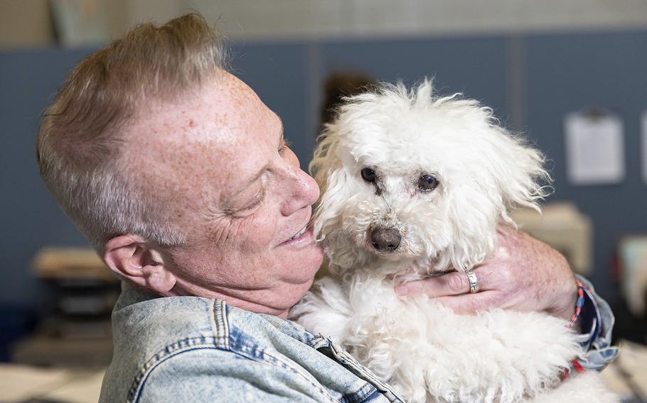 Mark Goldstein rejoicing after finally getting his adopted dog by No Dogs Left Behind after the CDC lifted a ban that blocked the dogs from entering the country, at The Ark at JFK, Brooklyn, New York, Thursday, March 23, 2023. 