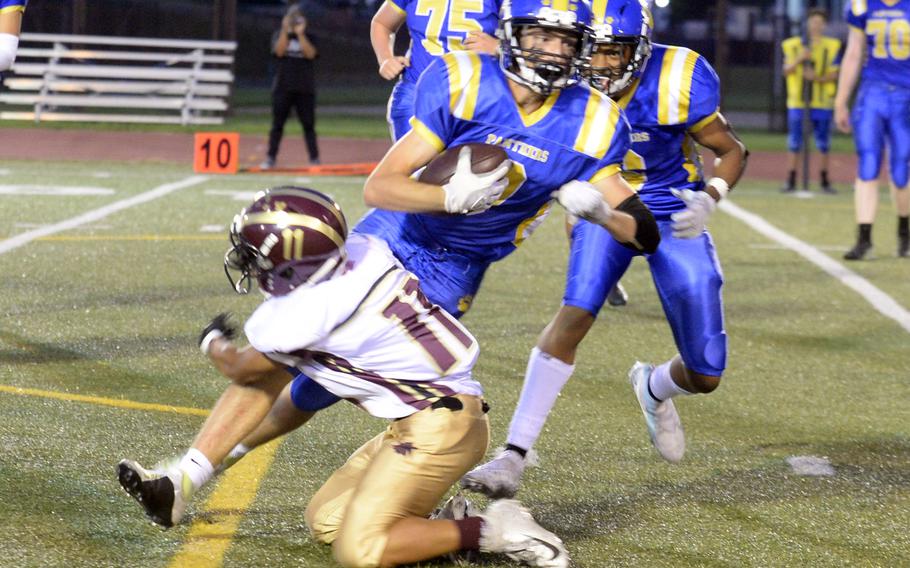 Yokota's Tate Rannow gets wrapped up by Matthew C. Perry's Eddie Pacleb.