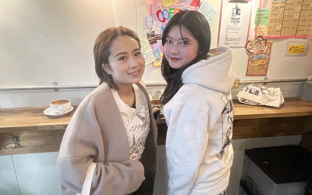 Taylor Swift fans Hinko Nishizki, left, and Rinka Tomomo visit Turret Coffee in Tokyo, Feb. 15, 2024.