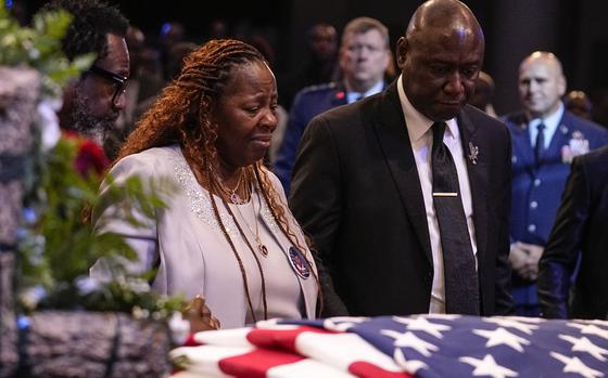 Chantemekki Fortson, left, the mother of slain airman Roger Fortson and Trial lawyer Benjamin Crump stand at his casket during his funeral at New Birth Missionary Baptist Church, Friday, May 17, 2024, near Atlanta. (AP Photo/Brynn Anderson)