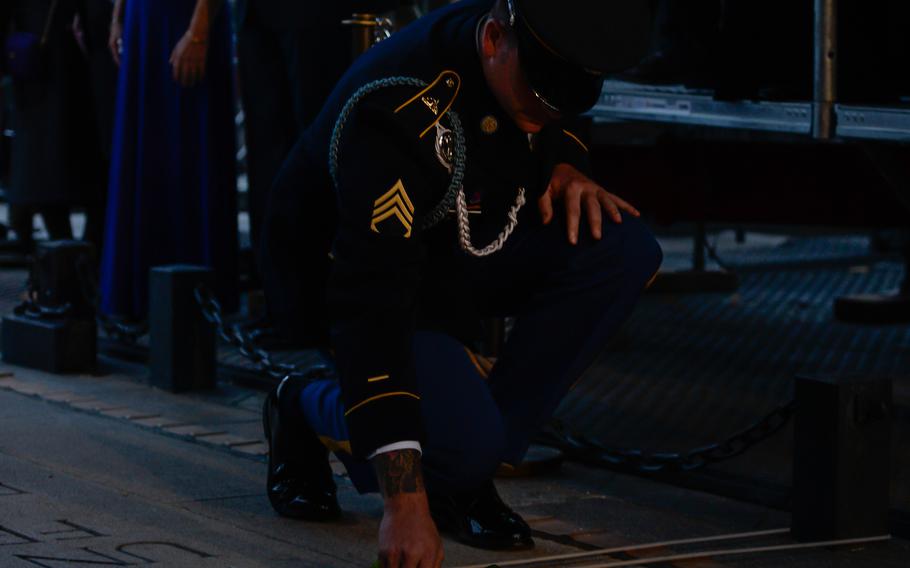 A member of the Society of the Honor Guard, Tomb of the Unknown Soldier lays a rose at the eternal flame below the Arc de Triomphe, in Paris, Oct. 26, 2021. Tomb guards are volunteers selected from the ranks of the 3rd U.S. Infantry Regiment (The Old Guard), headquartered at Fort Myer, Va.