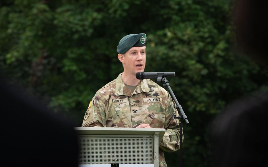 Col. Reid Furman speaks to a crowd at Pulaski Barracks in Kaiserslautern, Germany, on July 11, 2024, after relinquishing command of U.S. Army Garrison Rheinland-Pfalz.