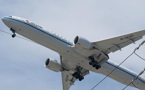 A Boeing 777-300 jetliner aircraft operated by Air China Ltd. makes a descent into Los Angeles International Airport in Los Angeles on May 28, 2021. MUST CREDIT: Bloomberg photo by Bing Guan.