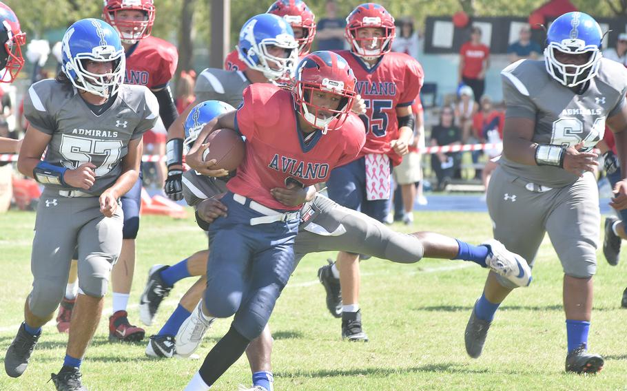 Aviano quarterback Andrew Walker spins away from a Rota tackler Saturday, Sept. 10, 2022, in the Saints' 42-0 victory over the Admirals in Italy.