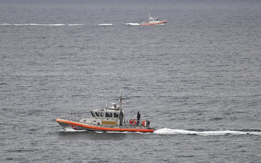 U.S. Coast Guard boats look for survivors after a boat capsized.