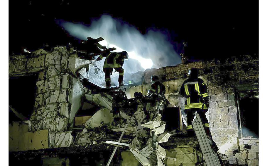 Firefighters work on the site of a burning building after a Russian drone attack in Odesa, Ukraine, Tuesday, April 23, 2024.