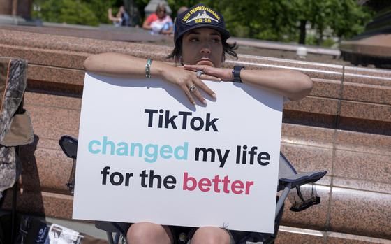 A TikTok content creator, sits outside the U.S. Capitol, Tuesday, April 23, 2024, in Washington as Senators prepare to consider legislation that would force TikTok's China-based parent company to sell the social media platform under the threat of a ban, a contentious move by U.S. lawmakers.