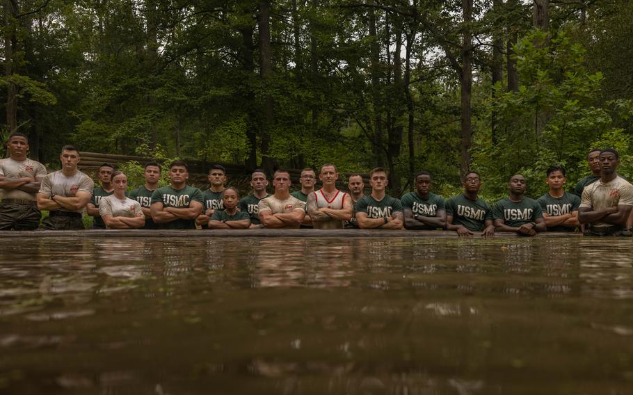 Marines pose for a photo in the water.