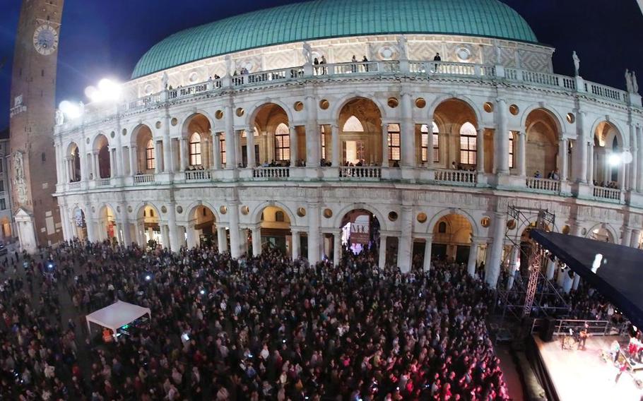 A crowd is gathered in an Italian piazza.