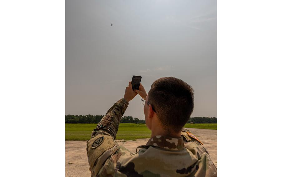 Army Sgt. Mickey Reeve of Task Force 39 scans a drone with his cellphone at McEntire Joint National Guard Base, S.C., on July 17, 2023. The task force is testing an app that is intended to help people report drone sightings to the U.S. military.