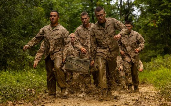 Marines carry ammo cans.