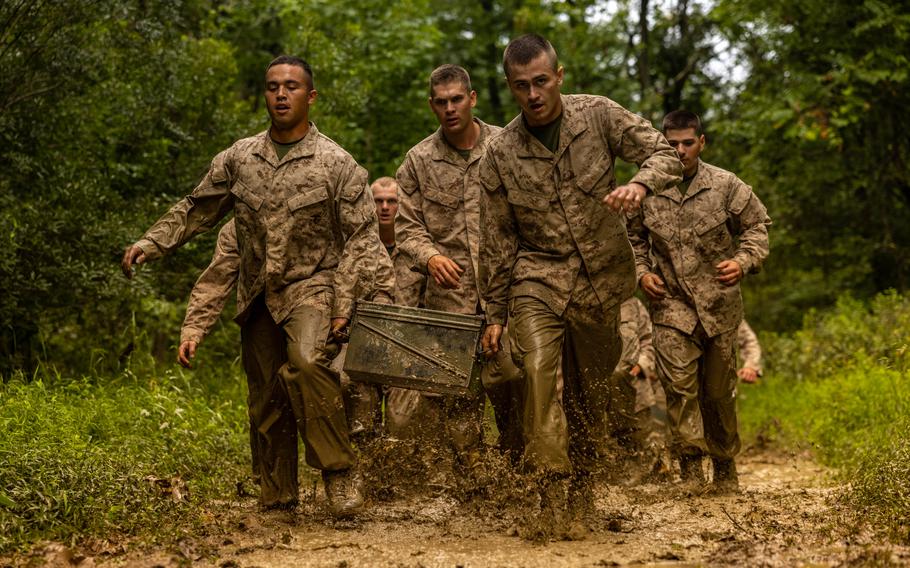 Marines carry ammo cans.