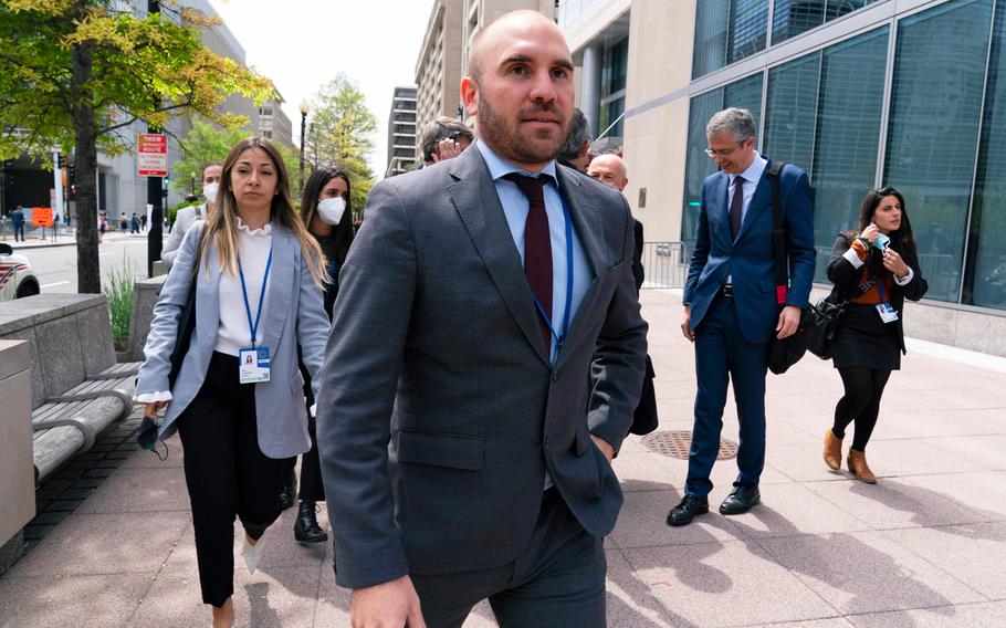 Argentina's Economy Minister Martin Guzman walks outside of the International Monetary Fund, IMF, building during the IMF Spring Meetings, in Washington, April 21, 2022. Guzman announced his resignation on Saturday, July 2, via twitter. 