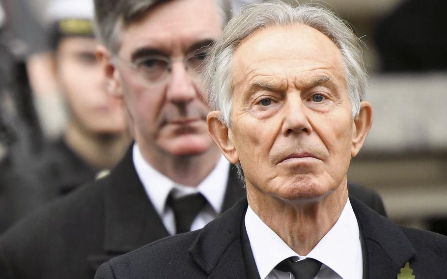 Former Prime Minister Tony Blair, right, attends a service at the Cenotaph, in Whitehall, London, on Nov. 14, 2021. Queen Elizabeth II on Saturday, Jan. 1, 2022, appointed Blair to be a Knight Companion of the Most Noble Order of the Garter, the most senior order of knighthood.