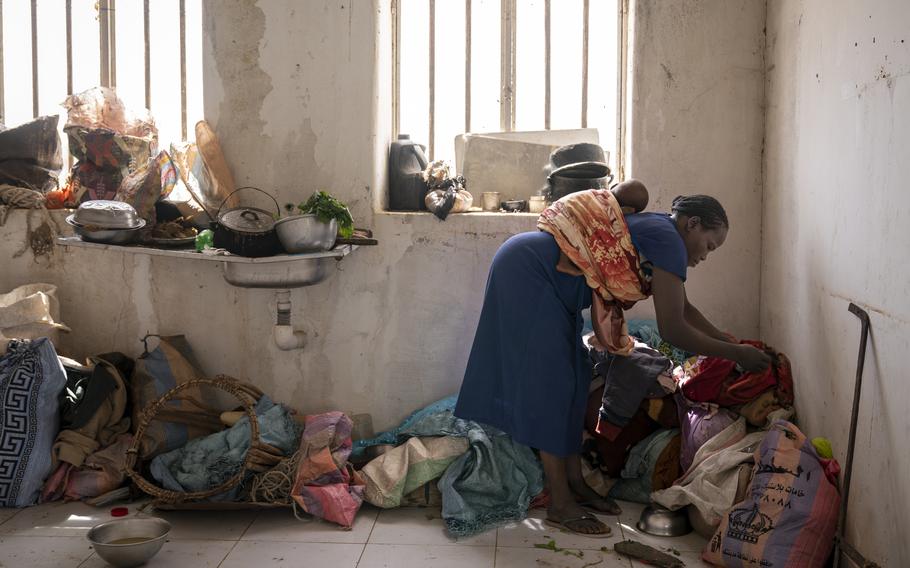 A woman arranges her belongings in a damaged hospital building, another site in Sirba where displaced people are sheltering. Last year, the town was nearly destroyed or burned to the ground multiple times, and more than 144,000 people were impacted. Reports said the violence in Sirba targeted ethnic communities, particularly the Eringa tribe.