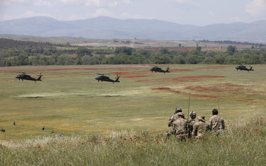 U.S. Black Hawk helicopters take part in the Swift Response 22 military exercise at the Krivolak army training polygon in the central part of North Macedonia, on Thursday, May 12, 2022.