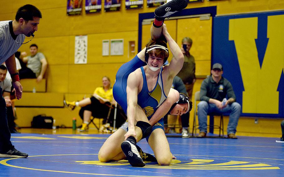 Wiesbaden's Jacob Lane tries to flip Ramstein's Kydan Echard during the 144-pound semifinal at the Warrior Wraggle on Jan. 13, 2024, at Wiesbaden High School in Wiesbaden, Germany.