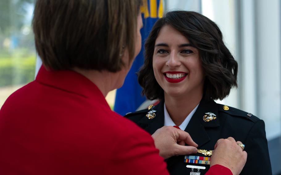 Retired Marine Corps Lt. Col. Amy McGrath pins on Marine 1st Lt. Brenda McCarthy’s wings at Naval Air Station Pensacola, Fla., May 27, 2021. McGrath, the first female weapons systems officer in the Marines, pinned flight wings on the last female WSO as the service shifts from two-seat fighter aircraft to one-seaters. 