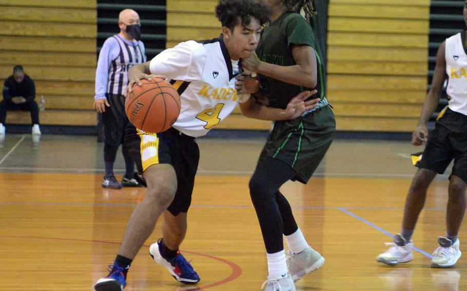 Kadena's Cory Tripp drives against Kubasaki's Carlos Cadet during Sunday's third-place game. The Dragons won 63-56.