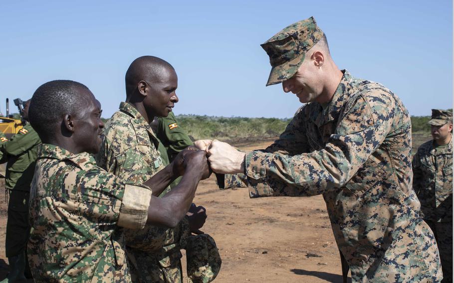 U.S. Marines and sailors celebrate with members of the Uganda People’s Defense Force at Camp Singo, Uganda, in 2020. Top priorities for U.S. Africa Command include countering terrorism, strengthening relationships with allies and partners and checking Chinese and Russian interference.
