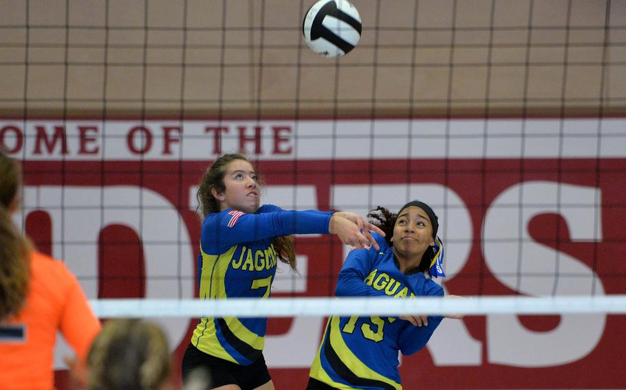 Sigonella's Averi Chandler, right, gets out of the way as teammate Emmy McCarthy receives a Spangdahlem serve in the 2019 Division III final  in Kaiserslautern, Germany. Following a year with no competition because of the coronavirus, The Jaguars will only have one player from the 2019 team returning