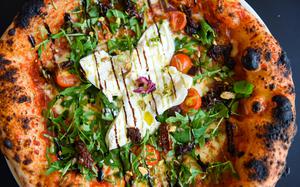 The burrata pizza at Nuovo Pizzeria in Manama, Bahrain, is a showstopper. It features a marinara base with fior di latte, sun-dried tomatoes, olives, cherry tomatoes and fresh arugula, finished with a whole burrata and a drizzle of pistachio cream. 
