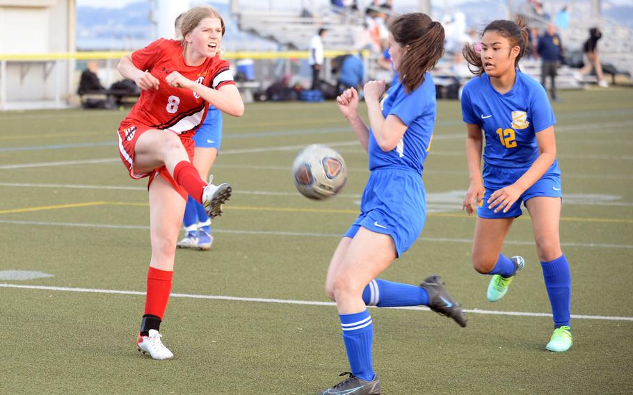 Nile C. Kinnick's Bree Withers boots the ball against Yokota defenders Lucy Wellons and Angelina Sylvain during Friday's DODEA-Japan soccer match. The teams played to a 1-1 draw.