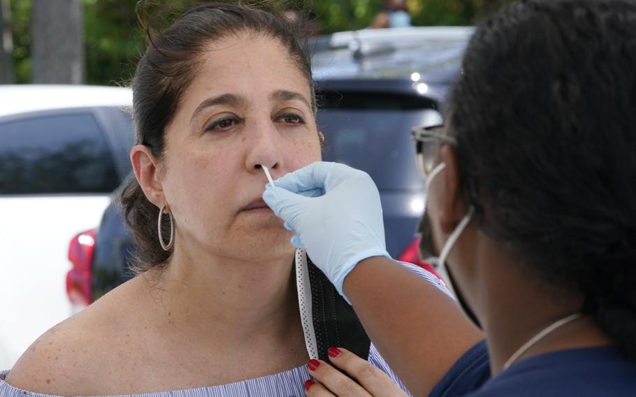 Raquel Heres gets a COVID-19 rapid test to be able to travel overseas, Saturday, July 31, 2021, in North Miami, Fla. 