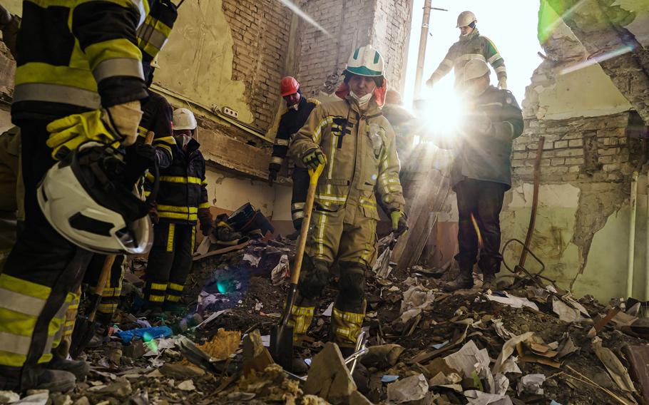 Firefighters clean up debris inside the Kharkiv Regional Administration building after it was destroyed by Russian bombardments, in Kharkiv, Ukraine, on March 25, 2022.