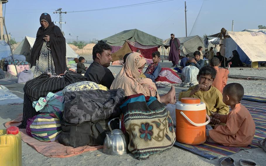 Afghan families sit outside their tents in an open area on the outskirts of Chaman, a border town in the Pakistan’s southwestern Baluchistan province, Tuesday, August 31, 2021. 