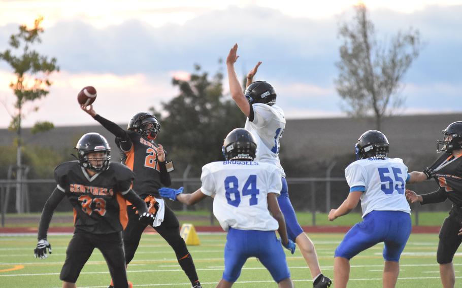 Spangdahlem’s Casey Supinger tries to throw the ball over Brussels’ defenders in Friday night’s game at Spangdahlem Air Base, Germany, against the Brigands. Brussels won the DODEA-Europe Division III matchup 39-36.