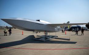 A model of a new aircraft on display outdoors.