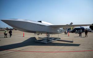 A model of a new aircraft on display outdoors.