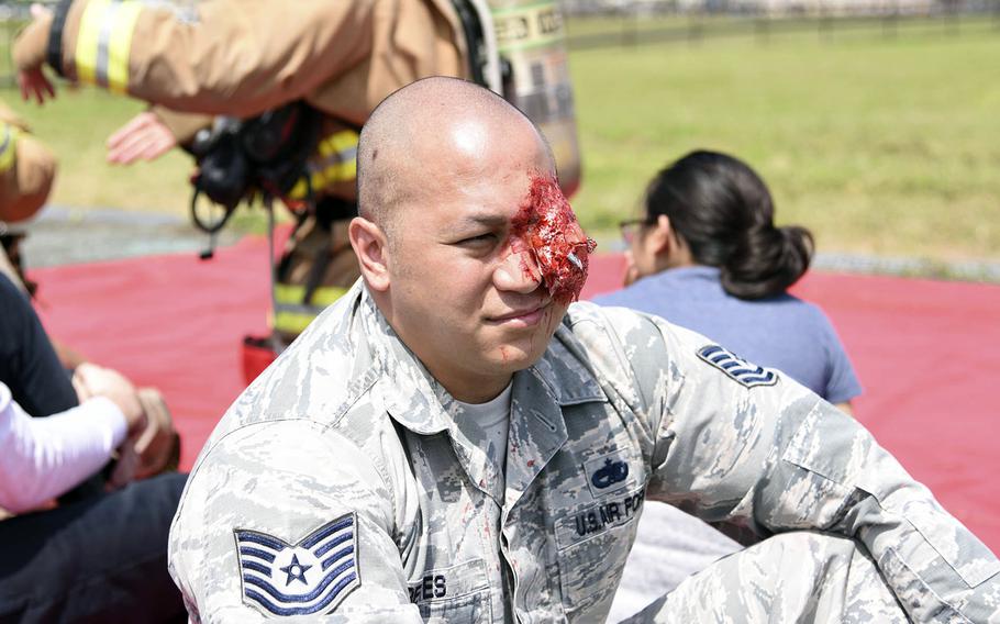 Air Force Tech. Sgt. Jason Reyes, 35, of Talofofo, Guam, waits for treatment during a major accident response exercise at Yokota Air Base, Japan, May 11, 2022. 