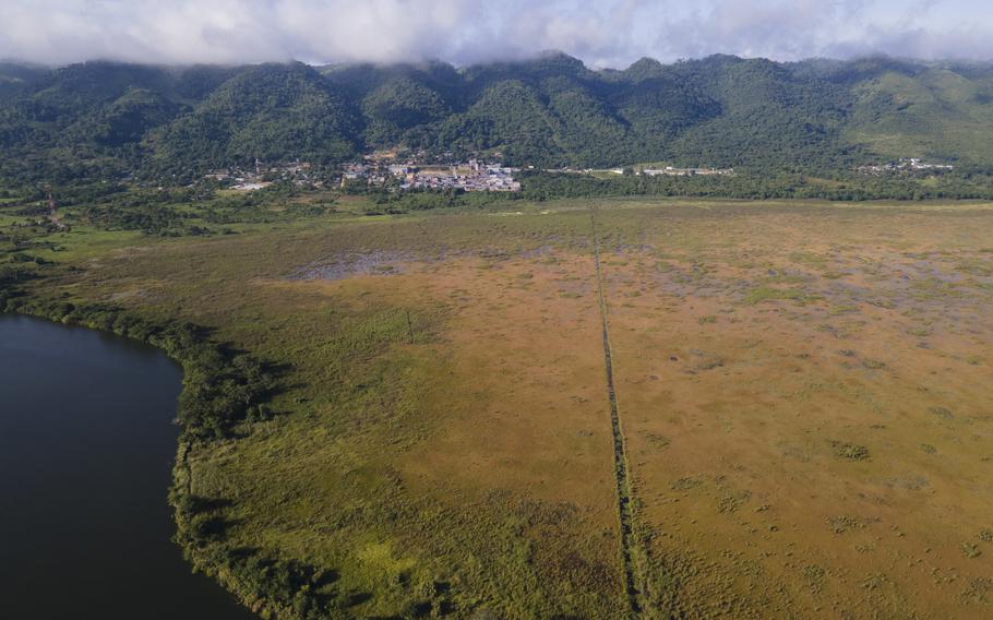 A line in a field divides Mexico, right, from Guatemala, near El Ceibo, in northern Guatemala, Thursday, Aug. 12, 2021. Central American migrants who seek U.S. asylum were deported by air from the U.S. to Mexico, then crossed into Guatemala by land to El Ceibo after being denied a chance to seek asylum under a pandemic-related ban. 