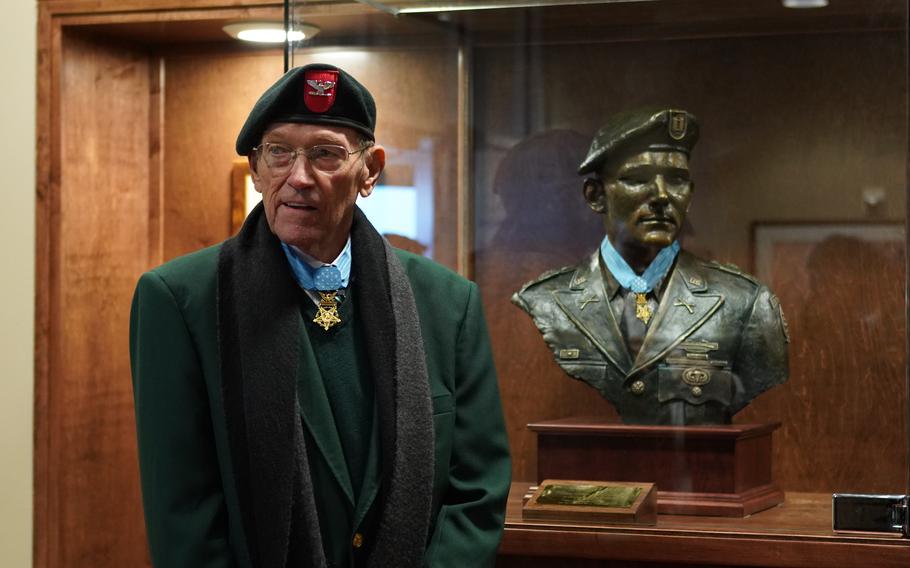 Retired Army Col. Roger H.C. Donlon poses next to the bust supporting his Medal of Honor after a ceremony held in his honor at Eglin Air Force Base, Fla., on Dec. 5, 2018. Donlon, the first American to receive the Medal of Honor in the Vietnam War, died Thursday, Jan. 25, 2024, at the age of 89.