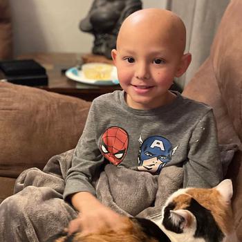 Sean Pine pets O'Malley, the family cat, at his home at Yokota Air Base, Japan, in January 2022.