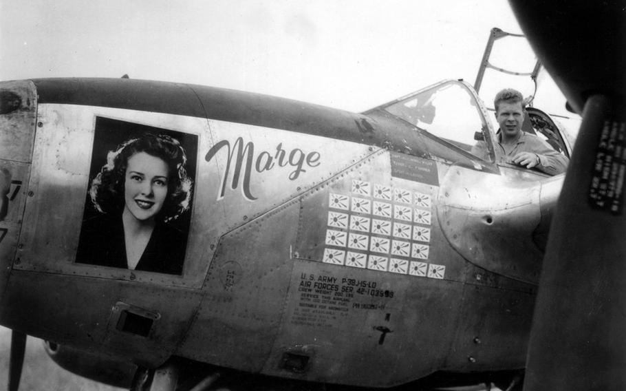 In this photo taken in March 1944 in the Pacific, Richard Bong, then a captain in the U.S. Army Air Force, sits in the cockpit of his P-38 fighter plane adorned with an image of his girlfriend, Marge, and a scoreboard tallying his 25 aerial victories over Japanese aircraft.