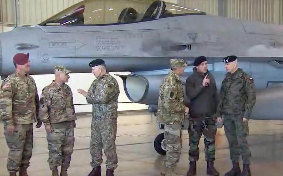 Lt. Gen. Erik Kurilla, XVIII Airborne Corps commander, left, Gen. Christopher G. Cavoli, commander, U.S. Army Europe-Africa, 2nd from left, and Air Force Gen. Tod Wolters, NATO supreme allied commander, talk to counterparts in front of a Polish F-16 jet at Lask Air Base, Poland, March 1, 2022. 