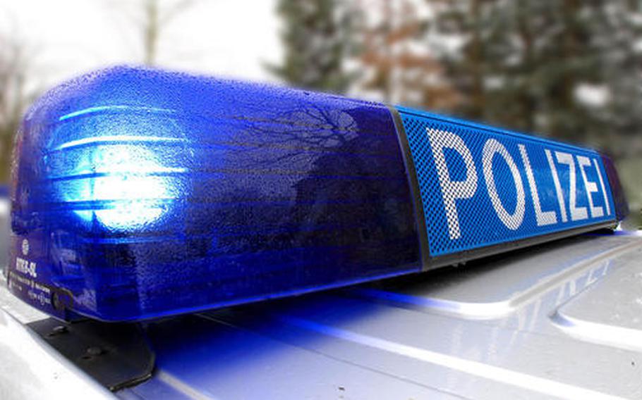 A blue light flashes on top of a police car.