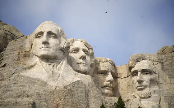 FILE -Visitors take in the massive sculpture carved into Mount Rushmore at the Mount Rushmore National Memorial Thursday, Sept. 21, 2023, in, Keystone, S.D. Fewer planes and helicopters will be flying tourists over Mount Rushmore and other national monuments and parks as new regulations take effect that are intended to protect the serenity of some of the nation's most beloved natural areas.(AP Photo/David Zalubowski, File)