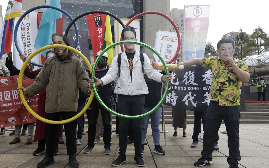 Human right groups gather on the United Nations international Human Rights Day, Friday, Dec. 10, 2021,  to boycott the Beijing Winter Olympics 2022 in front of the Bank of China building in Taipei, Taiwan. The groups are calling for the theme of this year's human rights day to be "Equality-Reducing inequalities, advancing human rights". (AP Photo/Chiang Ying-ying)