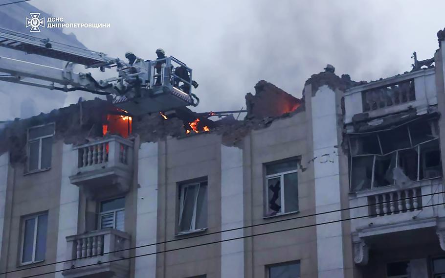 Rescuers work on the scene of a building damaged after a Russian attack in Dnipro, Ukraine, Friday, April 19, 2024.