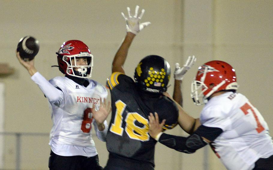 Nile C. Kinnick's Kellen Broach tries to unload as Kadena's Tre Shears draws a bead on him and Red Devils teammate Bobby Crisafulli tries to block Shears.