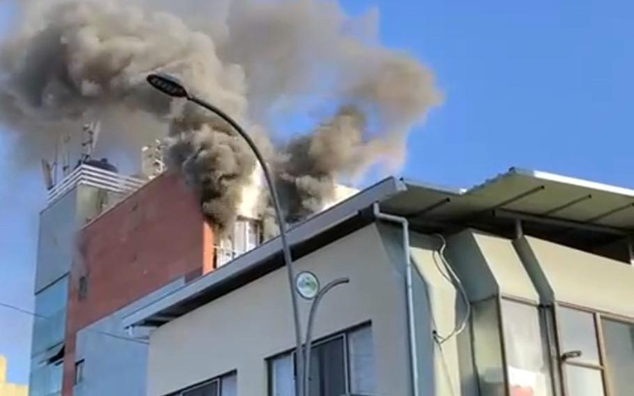 Smoke billows from an apartment building near Camp Walker in Daegu, South Korea, Nov. 13, 2021. 