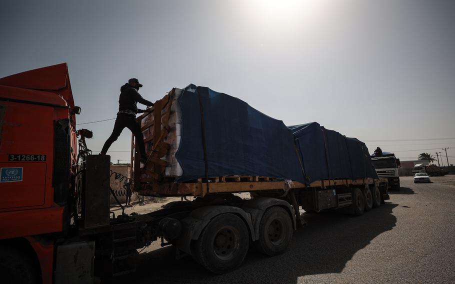 Humanitarian aid trucks enter the Gaza Strip through the Kerem Shalom crossing in Rafah on Saturday.